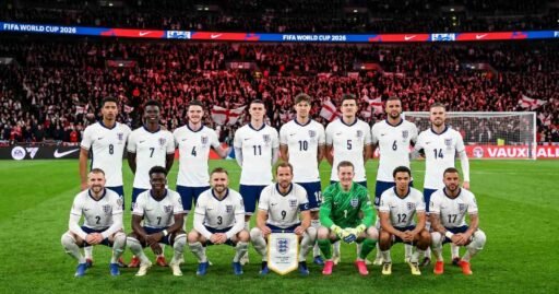 England national football team posing for official squad photo in white jerseys with Three Lions badge during FIFA World Cup 2026 qualifying match at night.