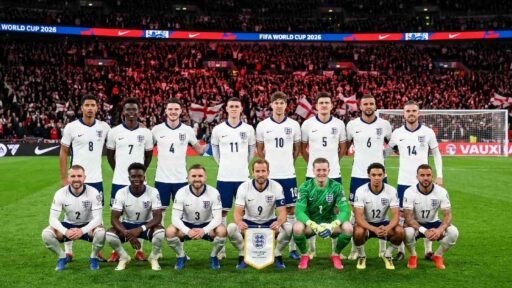 England national football team posing for official squad photo in white jerseys with Three Lions badge during FIFA World Cup 2026 qualifying match at night.