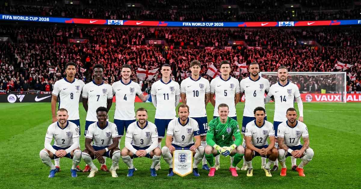 England national football team posing for official squad photo in white jerseys with Three Lions badge during FIFA World Cup 2026 qualifying match at night.
