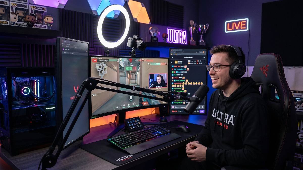 Esports content creator streaming live gameplay at a professional gaming setup with camera and microphone. 