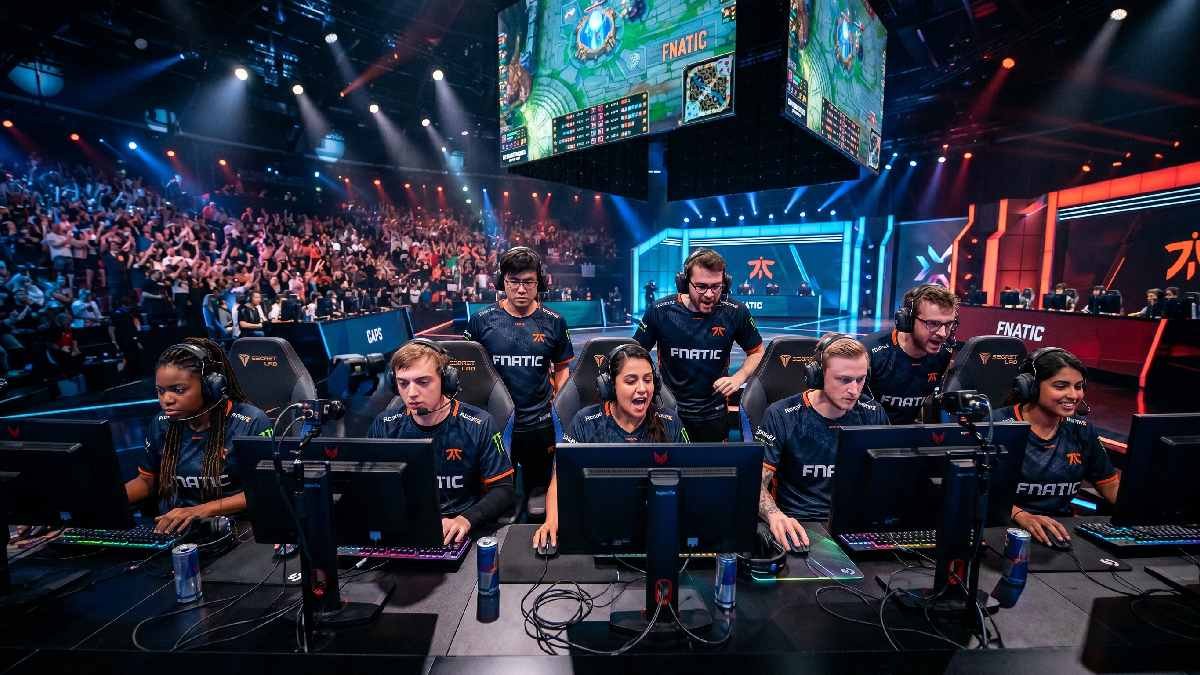 Diverse group of male and female esports players competing together at gaming stations in a modern arena. 